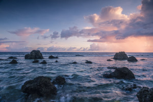 (ALL INTERNAL RIGHTS, LIMITED EXTERNAL RIGHTS) A view arcoss the rocky inner reef towards an evening sky filled with rainclouds and golden light near the village of Utwe on the Island of Kosrae, Micronesia. On the island of Kosrae in Micronesia The Nature Conservancy Protects the last Ka forest of its kind in the world with a ground breaking conservation easement involving 10 indigenous families. Photo credit: © Nick Hall